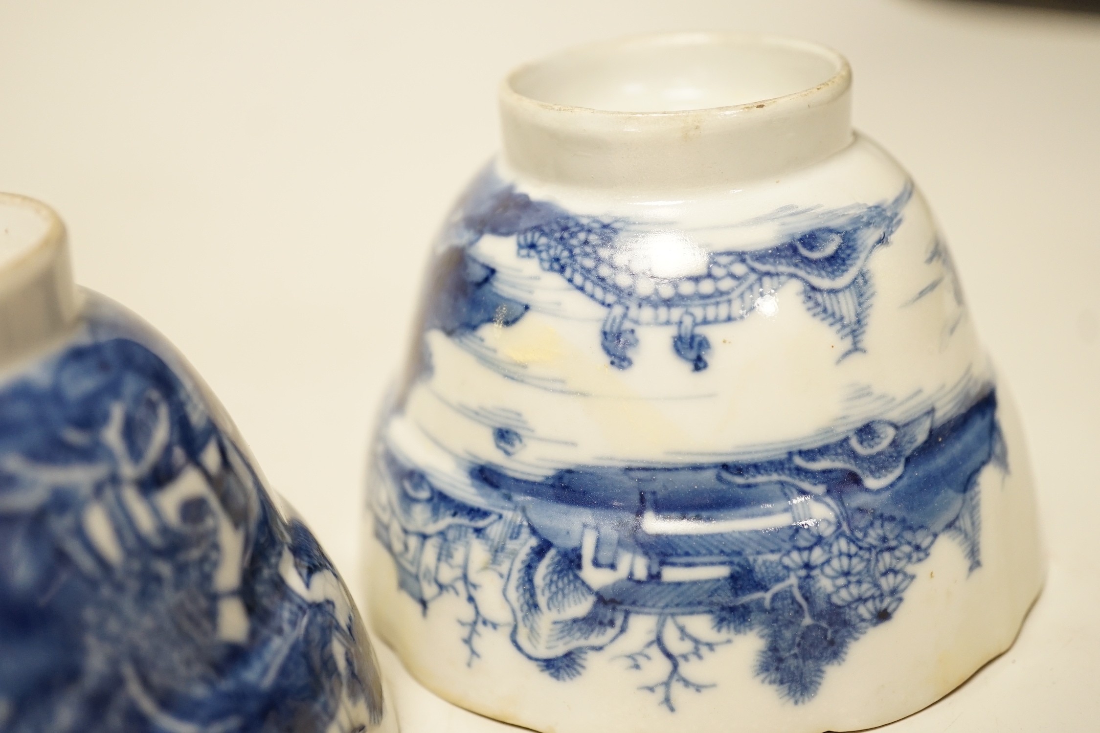 Two 19th century Chinese blue and white dishes and two 18th century tea bowls, largest 23cm diameter